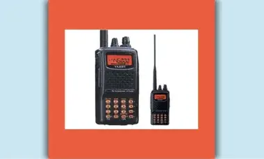 Two HAM radios, black with an orange screen, stand side by side. One is large and one is small.