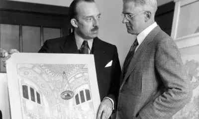 historic black and white photo of artist presenting his designs