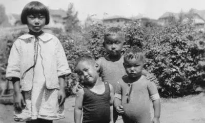 Alice Ito with her cousin, Niki, and her brothers, Hitoshi and Ise, as they cool off in a tub in a nursery field.