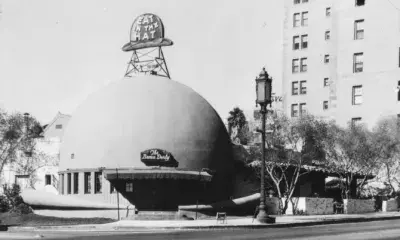 Exterior of a dome-shaped building with signage that reads "Eat in the hat" and "The Brown Derby"