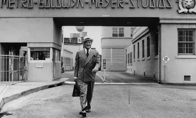 Actor Francis X. Bushman (1883–1966) walks from one of the entrance gates at the Metro-Goldwyn-Mayer Studios in Culver City
