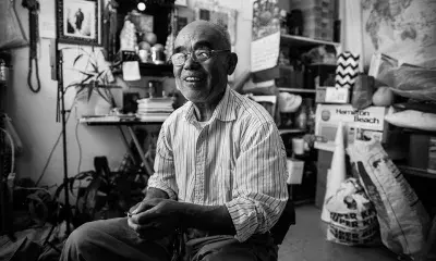 Portrait of Yingchang Song in a cluttered room