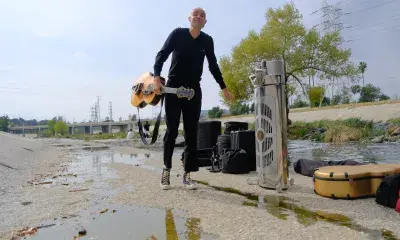 Performer Joshua Payne, sets up concert in the riverbed in Frogtown
