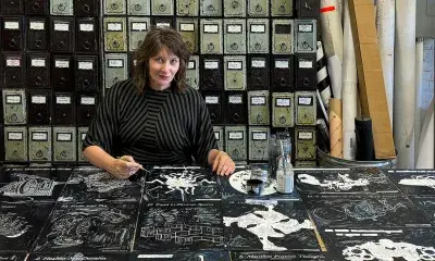 artist sits behind desk