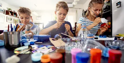Family members making crafts with plastic and paper products