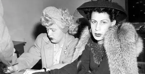 James Barlow, left, also known as Jeri Ryan, and August Coy, also known as Irene Paston, at the city hall police station. Photograph dated November 27, 1944. 