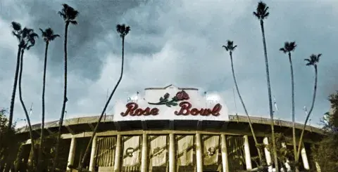 View of the Rose Bowl entrance flanked by tall palms on either sides