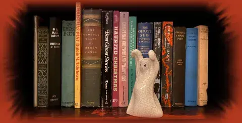 ceramic ghost on a book shelf