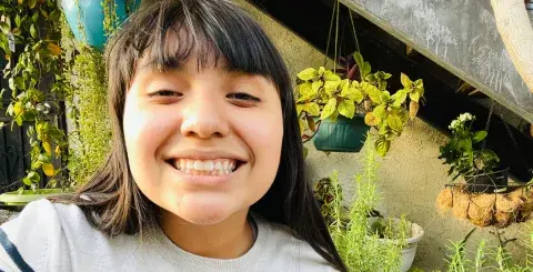 a smiling teen in a garden