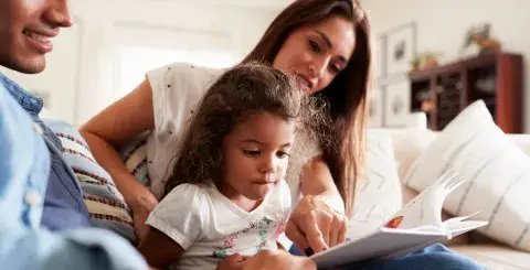 family reading a book together