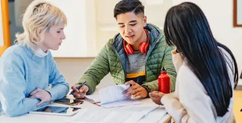 3 teens in a discussion about finances