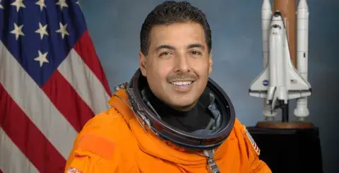 Astronaut Dr. Jose M. Hernandez in his orange spacesuit