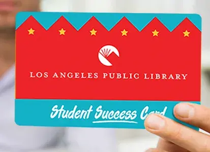 close up of hand holding a library card