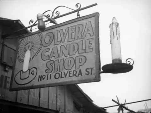 "Olvera Candle Shop" store sign.