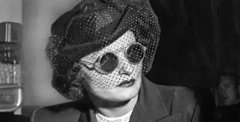 Brenda Allen wearing sunglasses and hat.