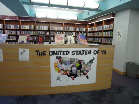 YA books on display with a banner beneath with the text "The United States of YA."