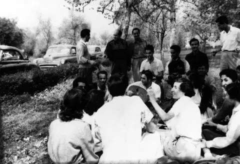 Students gathered in a circle at the park.