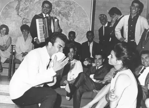 Gharib-Afshar Parviz performing in front of a crowd.