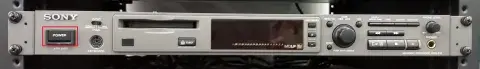 Front view of the minidisc player with a red rectangle showing where the power button is.