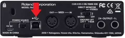 Backside of the Roland Rubix22 with a red arrow showing where to connect the power cable.