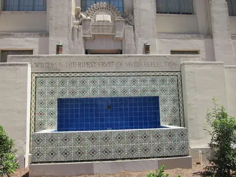 Fountain near the library's entrance with the inscription "Wisdom is the Ripest Fruit of Much Reflection."