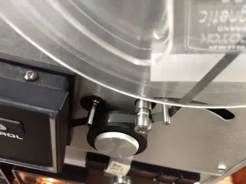 Audio tape going through pinch roller into take up reel.