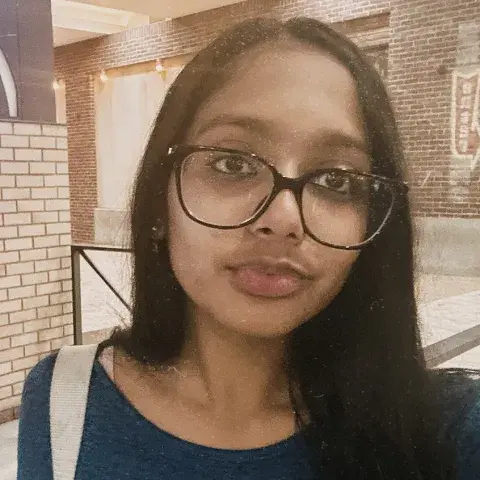 Shravanthi Raja, a young woman wearing glasses.