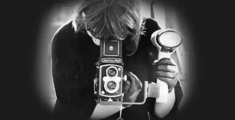 Women using a twin lens camera with a waist-level viewfinder.
