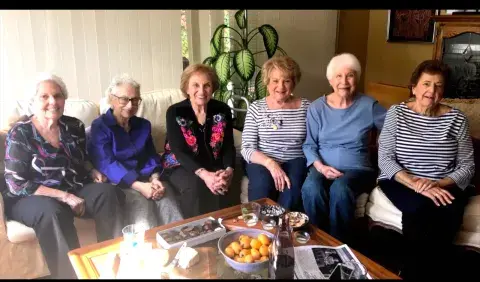 Six Jewish woman sitting around a table.