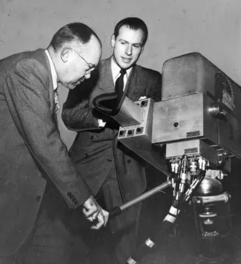 Hilton Tupman and Klaus Landsberg look at a TV camera