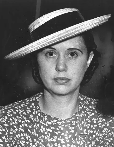 Ann Forst wearing a hat and floral dress