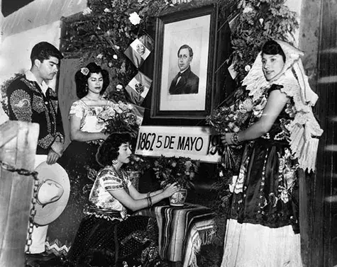 historic Avila House on Olvera Street participants placed flowers before a portrait of Gen. Ignacio Zaragaza, who overthrew the Austrian leader. In the group are: Miguel Garcia, Margarita Garcia, Virginia Henandez, and Beatrice Aguirre. 