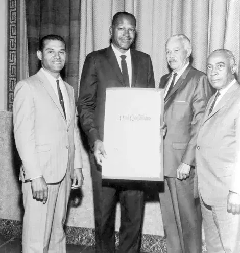 Paul R. Williams receiving a resolution from city Councilmen Tom Bradley, Billy Mills, Gilbert Lindsay in 1965