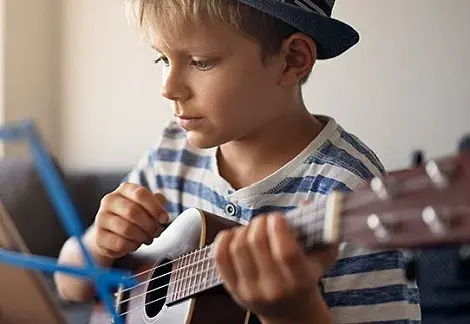 boy playing a guitar