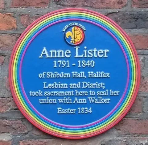 a rainbow plaque at Holy Trinity Church