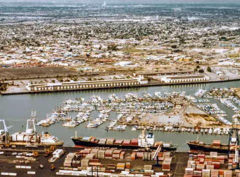 Showing an aerial view of the Matson Terminal as seen from Terminal Island looking across the East Channel ca. 1981