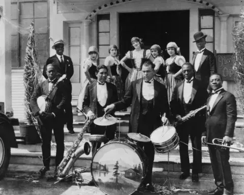 Black band poses with dancers