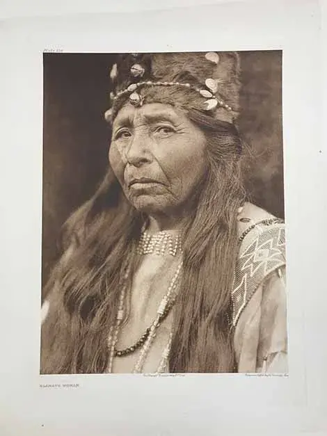 Klamath Woman wearing a crown type of head dress, looking straight into the camera