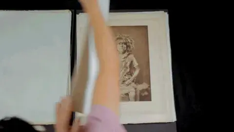 Moving image. The author Rudy Ruiz looking through the photograph plates of The North American Indian 