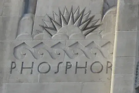 Relief of sunrise below sculpture of Phosphor