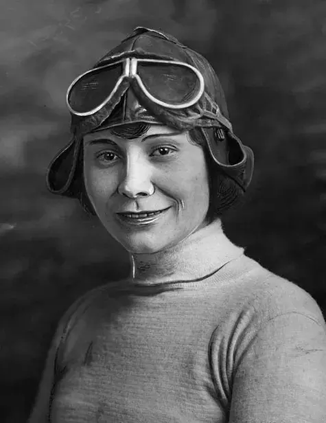 Aviatrix Miss Gladys Roy posing in helmet and goggles