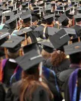 college graduation ceremony with all in black cap and gowns