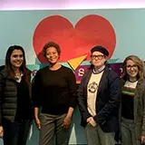 4 lawers in front of the Teenscape sign