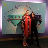 2 therapists writers in front of teenscape sign