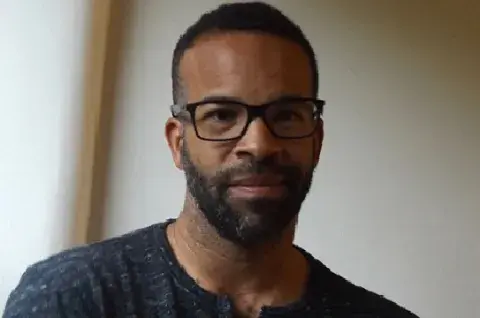 Douglas Kearney wearing glasses and smiling