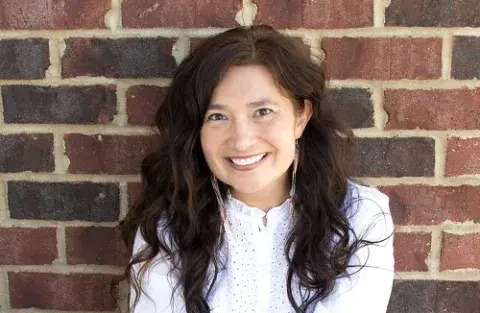 Felicia Zamora against a brick wall