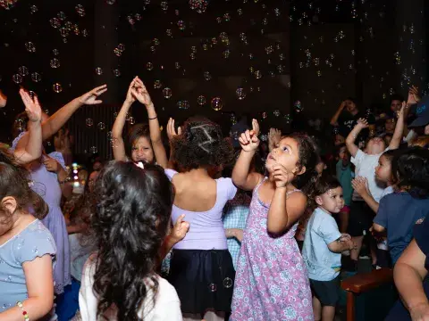 Children dance with bubbles