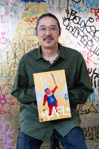 Artist Gaijin Fujita holding his book