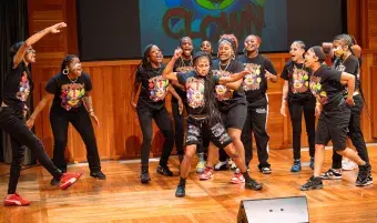 Teens perform dance on stage