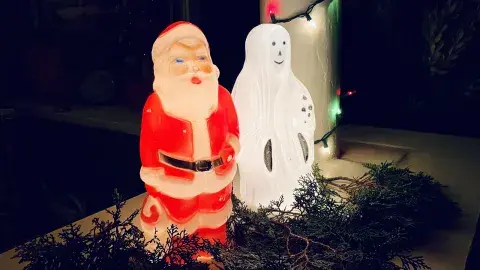 A santa and a ghost decoration on a porch